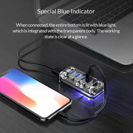 Orico Desktop USB Hub with 4 Ports and Blue LED Indicator Light shown connected to laptop and phone with transparent body and glowing blue LED