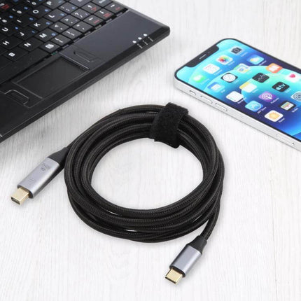 Versatile USB-C to Mini DP Adapter Cable for Displays, 1.8 Meters - braided 1.8m Type-C to Mini DisplayPort cable beside laptop and smartphone