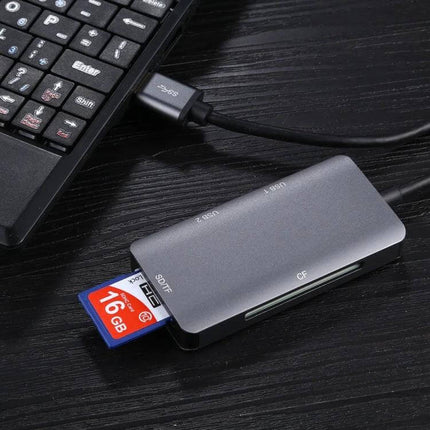 5-in-1 Multi-Card Reader for Easy Portable Data Transfer compact aluminum card reader with SD TF CF slots and 16GB card next to laptop