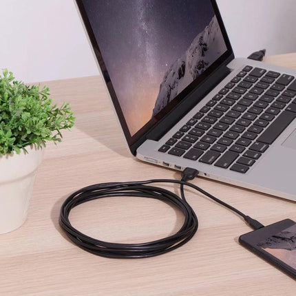 Handy Adapter for Seamless Device Connections During Daily Use — compact adapter linking laptop to phone and external drives on a desk