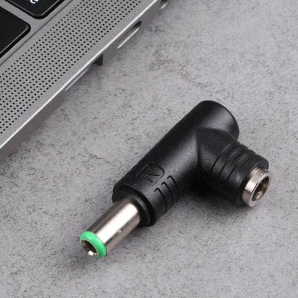 DC Power Adapter Connector for 6.3mm to 5.5mm Plugs angled black adapter next to laptop, converts 6.3mm to 5.5mm power plug
