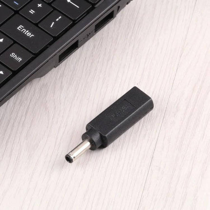 Compact USB-C Female to 4.5 x 3.0mm Male Adapter for Dell Laptops shown next to a laptop port, compact black power adapter
