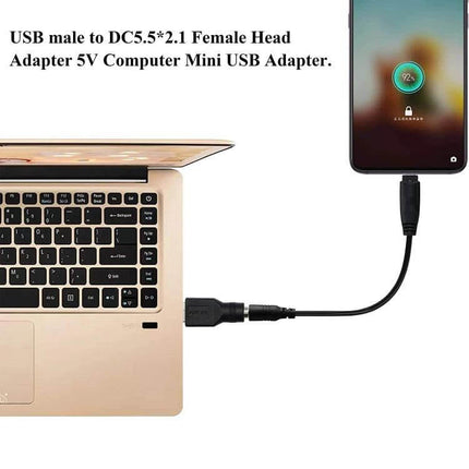USB to 5.5mm x 2.1mm Female Adapter for Device Connections showing USB charger powering phone from laptop via DC 5.5x2.1mm jack