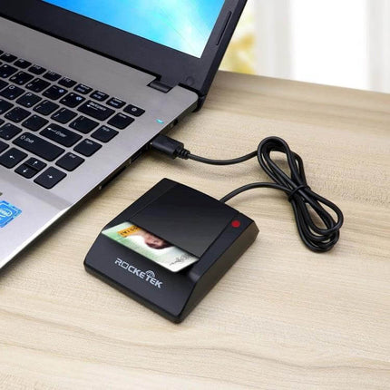 Rocketek USB Smart Card Reader for CAC, IC, and SIM Cards connected to laptop reading a CAC ID card for secure authentication