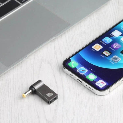 USB-C Female to DC Adapter for Computer and Laptop Charging shown next to laptop and smartphone, compact travel power convertor handling up to 5A