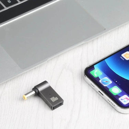 100W USB-C Female to DC Adapter for Acer Laptop Charging shown next to laptop and smartphone on desk