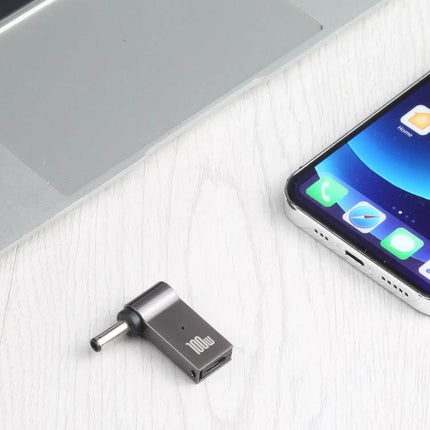 100W USB-C Female to DC Adapter for Laptop Charging shown beside laptop and smartphone on desk, compact 100W 5A charger adapter