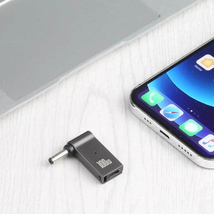 USB-C to DC Adapter for Charging Laptops and Portable Devices - compact black adapter beside laptop and smartphone