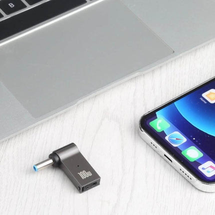 100W USB-C to DC Charging Adapter for Laptop Power Needs shown next to laptop and smartphone on desk, compact 100W 5A USB-C to DC adapter