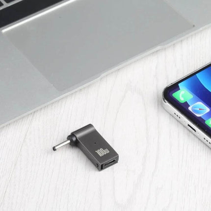 USB-C Female to DC Adapter for Laptop Charging Needs shown next to laptop and phone for travel-ready power