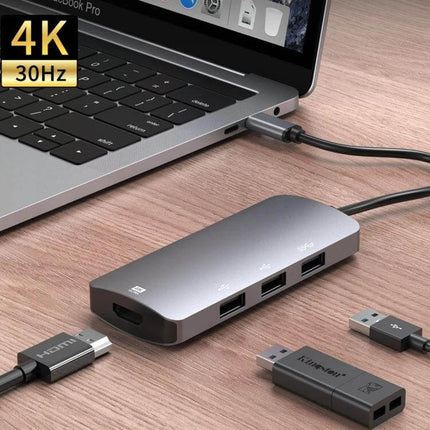 USB-C Multifunctional Hub for Everyday Device Connections connected to laptop with HDMI and USB peripherals, sleek aluminum dongle for 4K display and multitasking