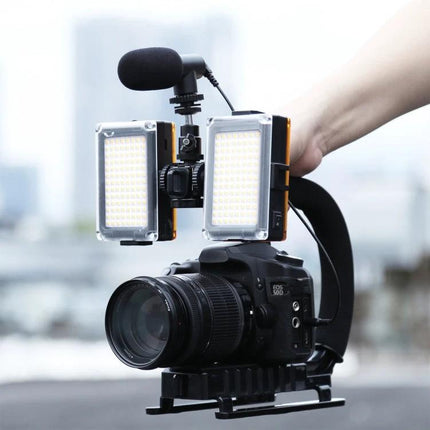 Portable Handheld Camera Stabilizer Kit with LED Light and Mic mounted on DSLR with dual LED panels and external microphone for vlogging