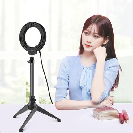 PULUZ Ring Light for Home Vlogging and Daily Photos showing ring light on tripod beside woman doing home vlogging and selfies