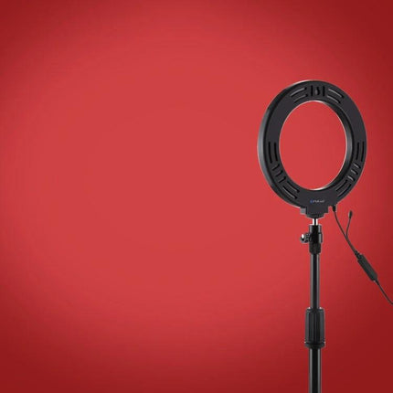Essential PULUZ Ring Light for Home Vlogging Sessions on adjustable stand against red background, 28 LED beads for soft even lighting