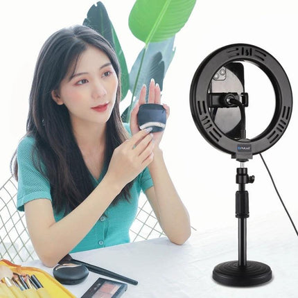 PULUZ LED Ring Light for Home Vlogging and Selfie Sessions showing a creator using makeup with ring light on desk tripod