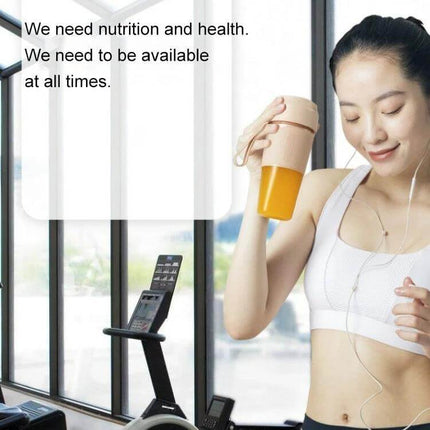 Portable Juicer Mini Electric Blender Pink For Smoothies On The Go - woman in gym holding pink mini blender with orange smoothie, cordless 300mL cup