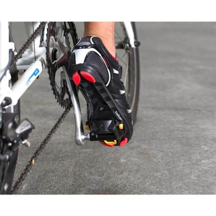 PROMEND Black Self-Locking Road Bike Pedal for Daily Riding attached to a cycling shoe on a road bike pedal showing locking mechanism