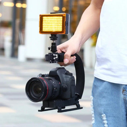 PULUZ C-Shaped Handheld Camera Stabilizer for Video Recording in use with DSLR and LED video light for smooth handheld footage