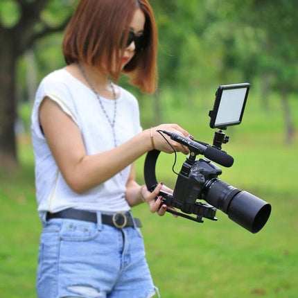 PULUZ C-Shaped Handheld Camera Stabilizer for Video Filming used by videographer outdoors for smooth multi-angle footage