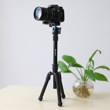 PULUZ Adjustable Metal Handheld Tripod Mount for DSLR and SLR Cameras shown supporting a DSLR on tabletop for vlogging and outdoor shoots
