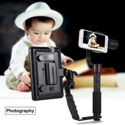 PULUZ L-Shape Handheld Grip with Cold Shoe Mounts for Cameras mounted with LED light and smartphone stabilizer next to baby portrait