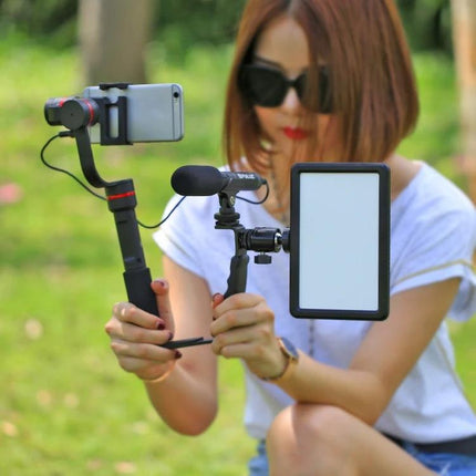 PULUZ L-Shape Handheld Grip with Cold Shoe Mounts for Cameras mounted with microphone and LED light for outdoor portrait shooting