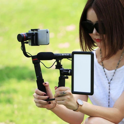 PULUZ Microphone for Everyday Video and Interview Recording mounted on a handheld rig with LED light and smartphone