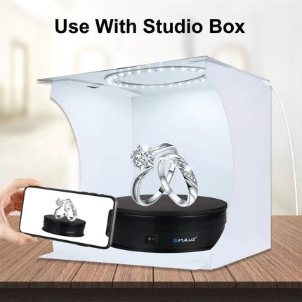 PULUZ 15cm Electric Rotating Display Turntable for Photography showcasing rings in a studio box with LED lighting