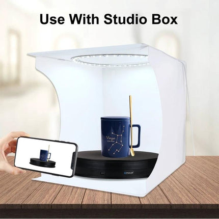 PULUZ 30cm Electric Rotating Display Turntable for Product Photography shown inside a studio box rotating a mug for consistent photo capture