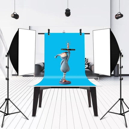 T-Shape Adjustable Background Support Stand for Photo Studios with blue backdrop, studio lights and tabletop prop