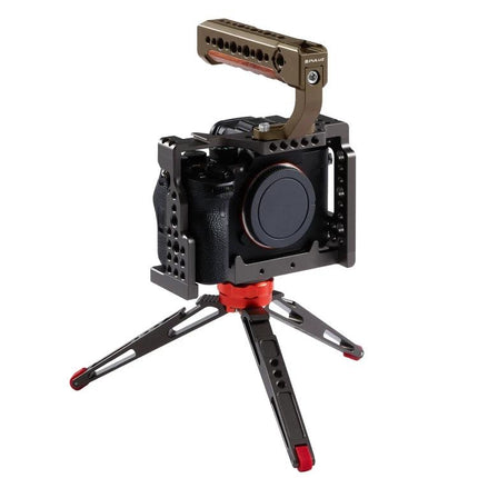 PULUZ Wooden Top Handle for Mirrorless Cameras with Cold Shoe Mount attached to camera cage and tabletop tripod