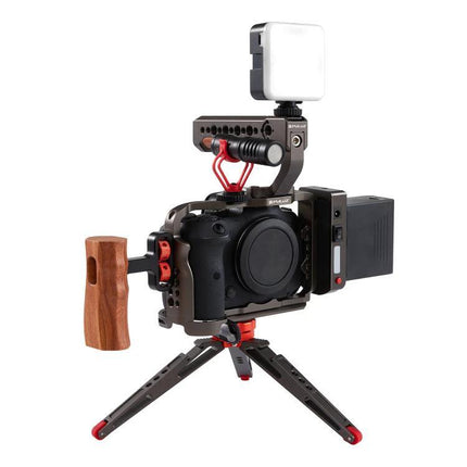 PULUZ Aluminum Camera Cage for Canon EOS Video Stabilization mounted on Canon camera with wood side handle, top handle, LED light and mini tripod