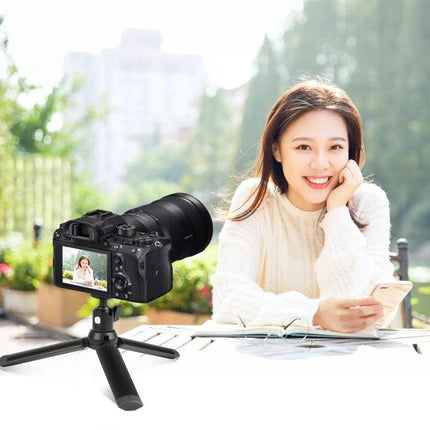 PULUZ Metal Tripod Ball Head Adapter for Camera Adjustments with Knob Lock mounted on mini tripod capturing outdoor portrait scene