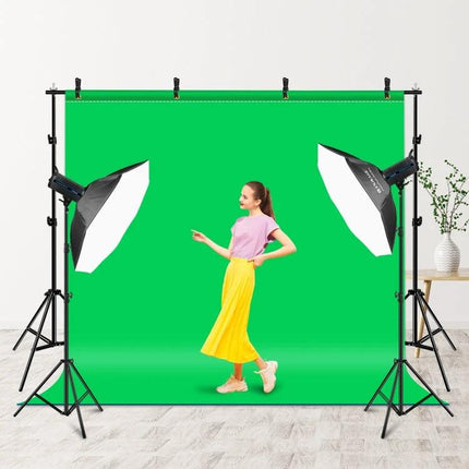 Photo Studio Background Support Stand with 2x3m Crossbar holding green screen backdrop with softbox lights and model in studio