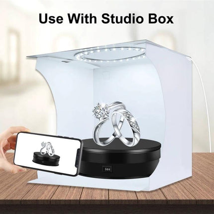 PULUZ 15cm Adjustable Speed Rotating Display Turntable Stand showcasing jewelry in a studio light box, smooth rotation for product photography