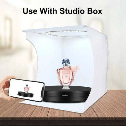 PULUZ 30cm Adjustable Rotating Display Stand for Showcasing Items in a studio box displaying a perfume bottle on a rotating black platform