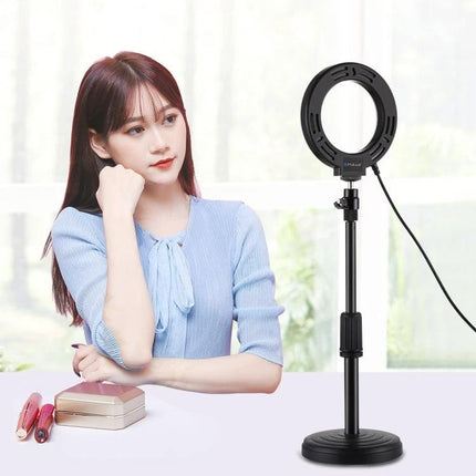 PULUZ LED Ring Light for Everyday Vlogging and Photography Sessions shown on stand illuminating a woman recording at home
