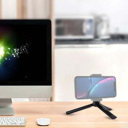 PULUZ Compact Metal Desktop Tripod for Travel Photography on desk holding smartphone beside desktop computer