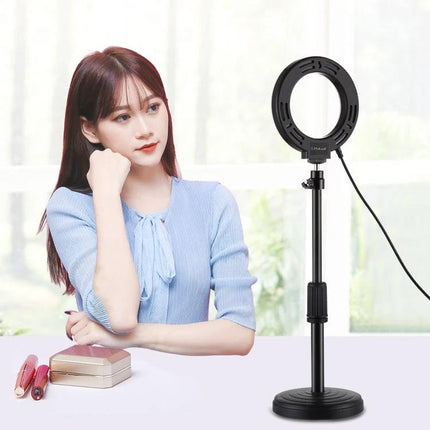 PULUZ 4.7 Inch Dimmable LED Ring Light for Video and Vlogging on stand beside vlogger doing makeup and video call