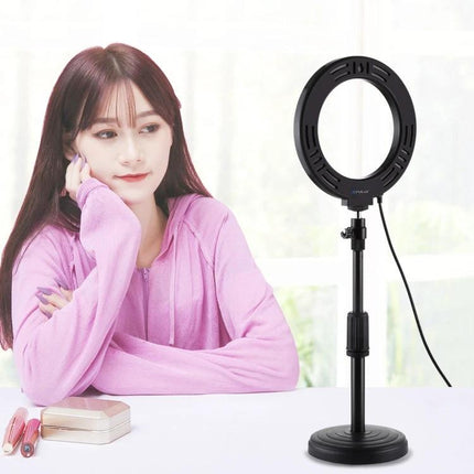 PULUZ LED Ring Light for Daily Video and Photo Essentials showing compact ring light on stand beside woman creating social media content