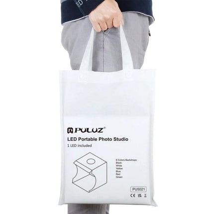 PULUZ Portable 20cm Folding Light Box for Product Photography portable foldable kit in white carry bag shown held by person