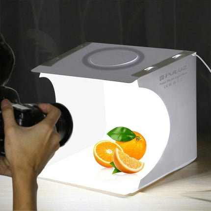 PULUZ Portable Ring LED Light Box for Small Item Photography showing oranges photographed inside lightweight foldable studio box with camera