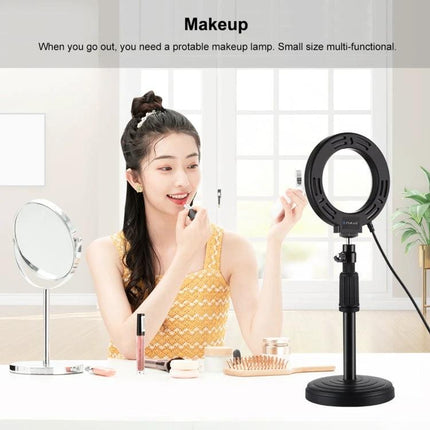 PULUZ Ring Light for Daily Selfies and Video Chats on desk beside woman applying makeup, portable LED ring light reducing shadows for natural selfies