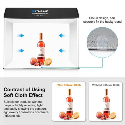 PULUZ Portable Photo Studio Light Box for Smartphone Shots showing a bottle and fruit inside softcloth-lit white backdrop