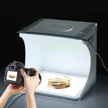 PULUZ 20cm Shadowless Light Pad for Product Photography showing jewelry on evenly lit small light table with camera capturing image
