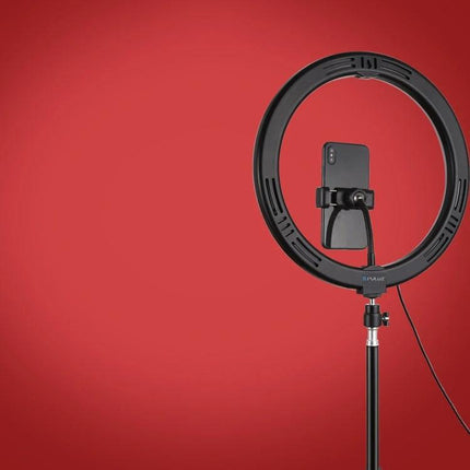 PULUZ Ring Light for Everyday Video and Photo Sessions shown mounted on a tripod with smartphone holder against red background