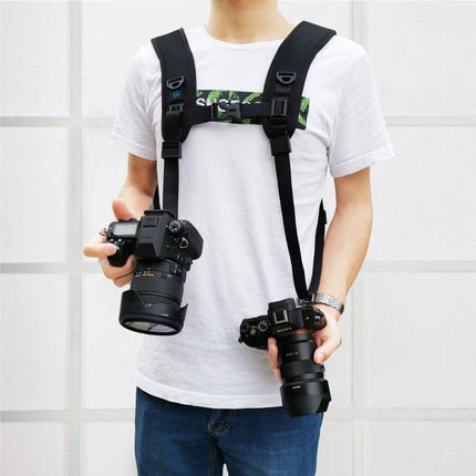 PULUZ Double Shoulder Harness with Soft Padding for DSLR Cameras worn by photographer holding two DSLR cameras