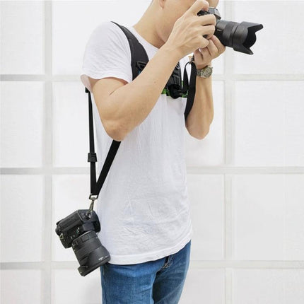 PULUZ Double Shoulder Harness with Soft Padding for DSLR Cameras worn by photographer holding two DSLR cameras