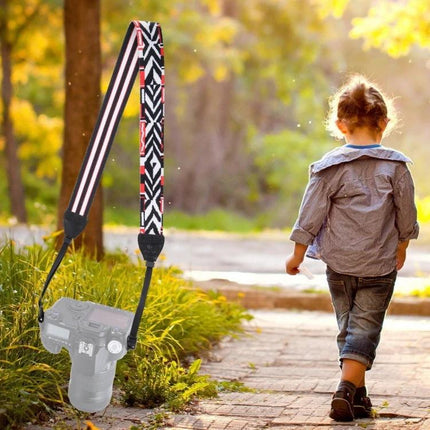 PULUZ Retro Ethnic Style Camera Neck Strap for SLR Cameras hanging from SLR in outdoor park scene, vintage ethnic patterned comfort strap