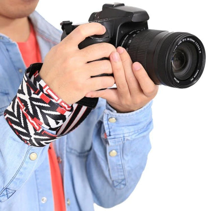 PULUZ Retro Ethnic Style Camera Neck Strap for SLR Cameras on a photographer holding a DSLR, vintage ethnic wrist strap pattern, secure comfortable carry